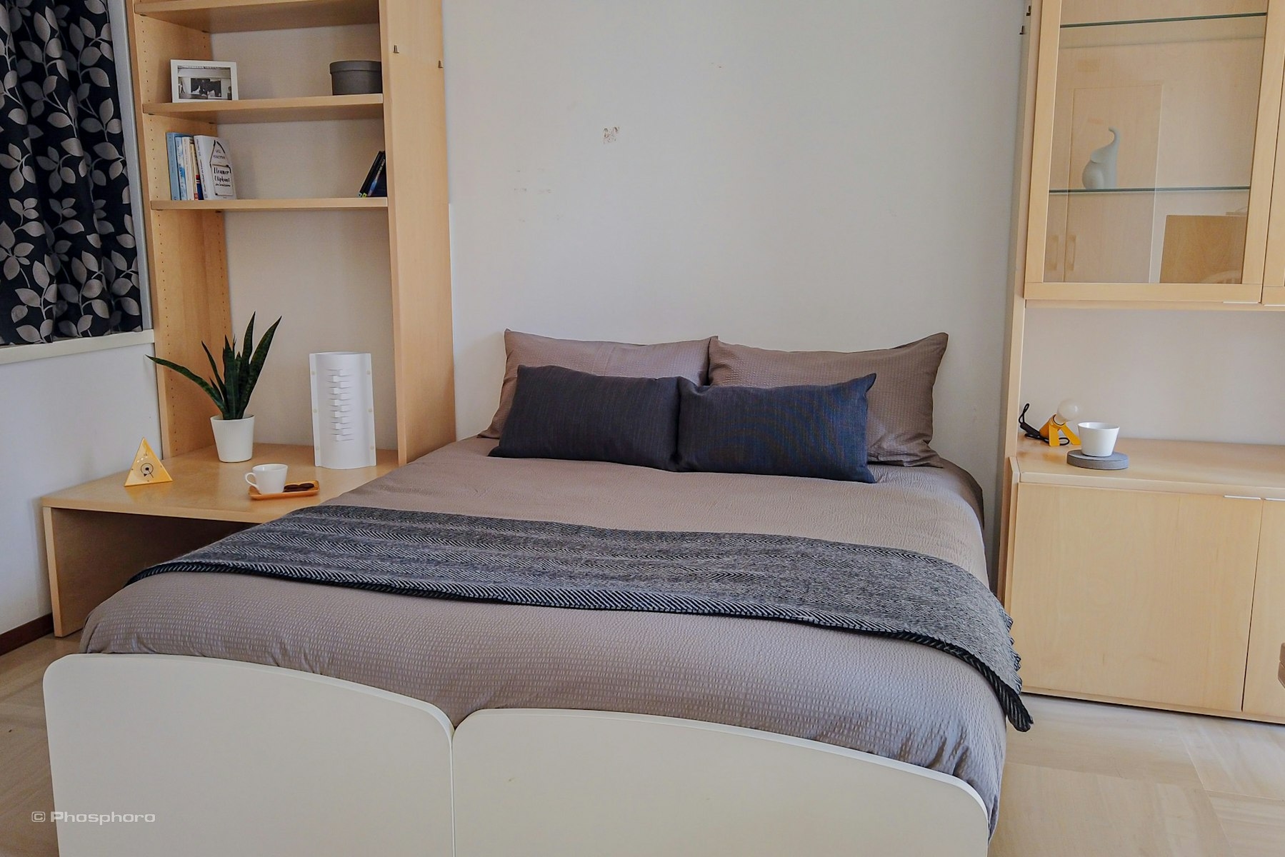 Bed in a spacious double room with private balcony.